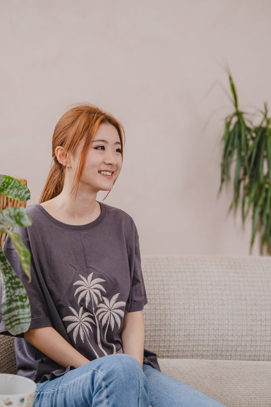 A Chinese girl wearing Loom & Sprout branded organic cotton t-shirt which is good for the skin. 