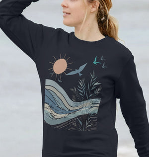 a woman in a sweatshirt featuring birds and the sun, showcasing a birds women's crewneck organic jumper design.
