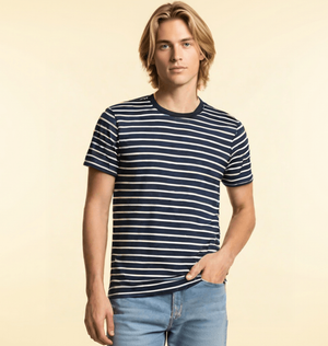 A man dressed in a white striped organic cotton t-shirt.