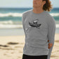 A man in a long sleeve shirt adorned with a boat print, showcasing the Timeless Voyage Men's Organic T-Shirts line.