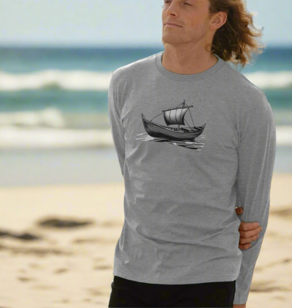 A man in a long sleeve shirt adorned with a boat print, showcasing the Timeless Voyage Men's Organic T-Shirts line.