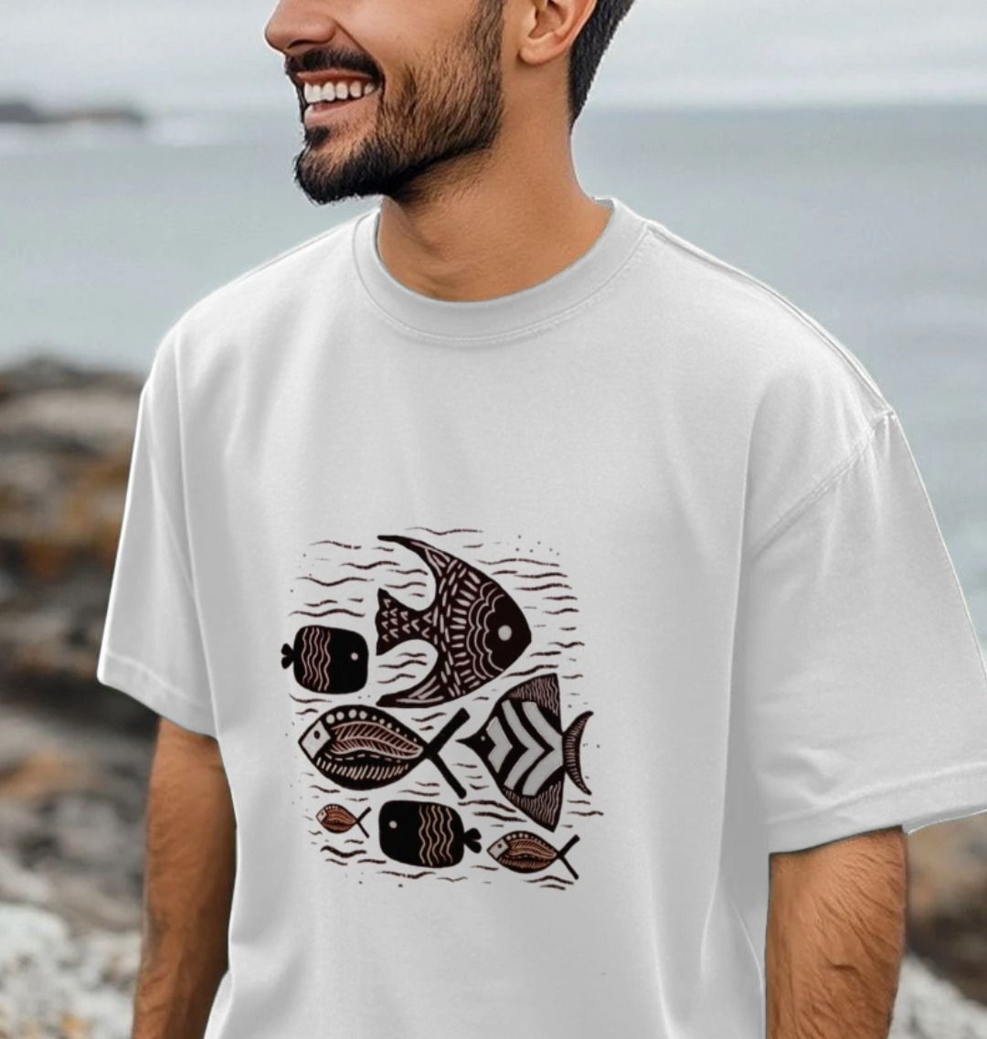 A man wearing a white t-shirt with a fish print, showcasing the Tribal Waters Men's Oversized T-Shirt style.