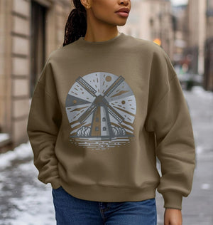 A woman in a brown oversized sweatshirt featuring a windmill design, showcasing a casual and eco-friendly style.