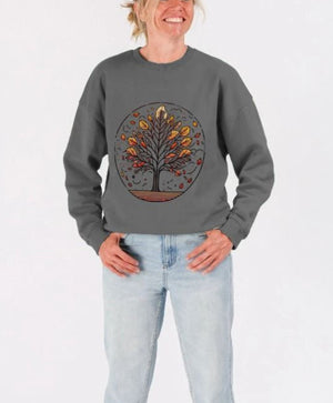 A woman models an oversized sweatshirt with a tree design at the center