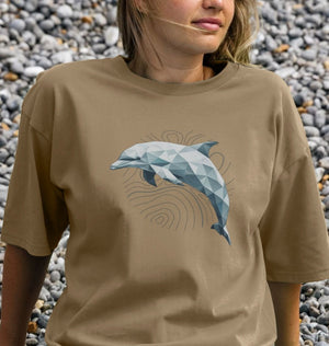 A woman wearing a Geo Dolphin oversized organic t-shirt featuring a dolphin graphic.
