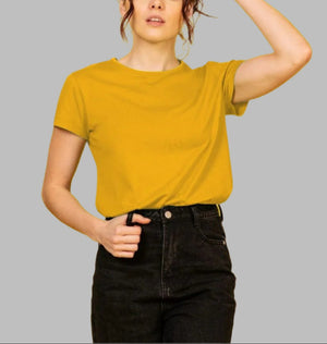 A woman wearing a yellow crew neck organic t-shirt, smiling and standing against a neutral background.