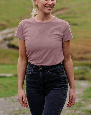A woman wearing a blue sweater and black pants, featuring a Women's ReSprout Organic Jumper design.