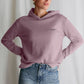 Women's relaxed fit hoodie in dusty pink, labeled "stronger than ever," showcasing a comfortable and stylish design