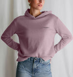 Women's relaxed fit hoodie in dusty pink, labeled "stronger than ever," showcasing a comfortable and stylish design